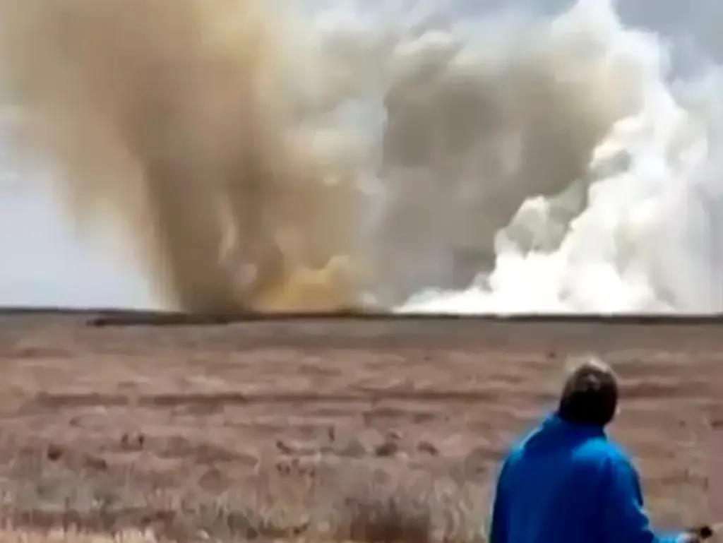 This still image taken from video shows a plume of smoke rising above a plain near Mountain Home Air Force Base in Idaho, where two Navy jets collided at an air show on May 17.