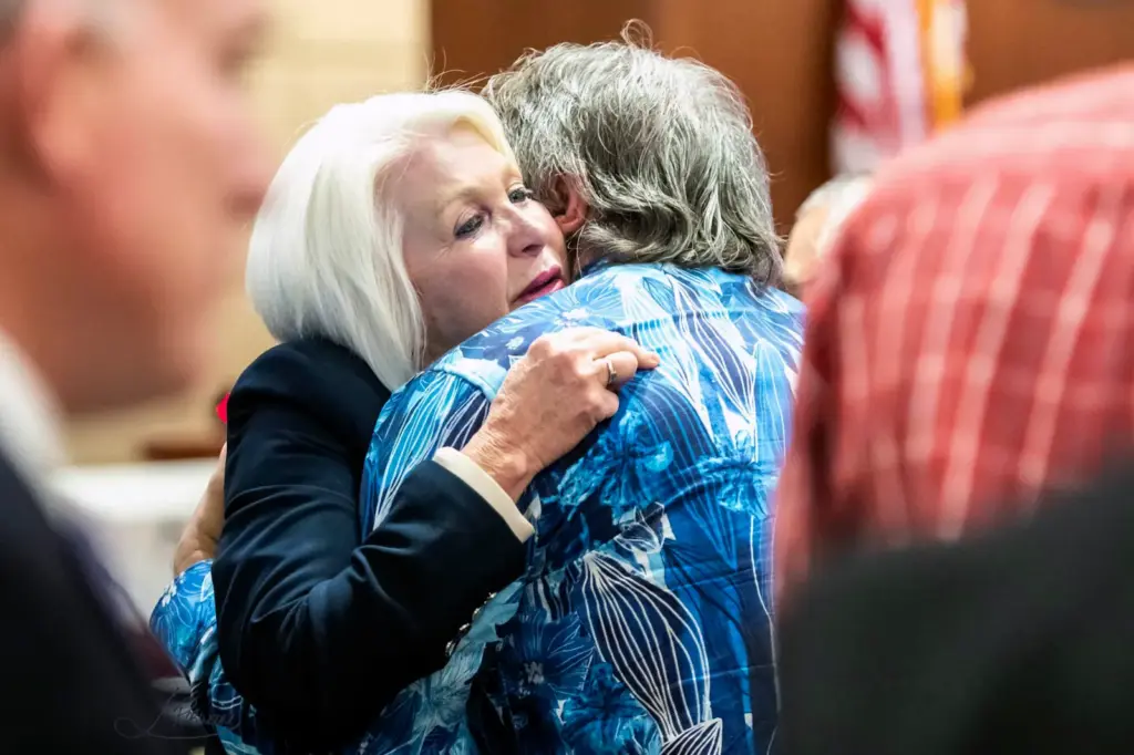Former Mesa County Clerk and Recorder Tina Peters, left, hugs Pastor Dave Bryan of the Church of Glad Tidings, who testified on Peters' behalf during a sentencing hearing for her election interference case at the Mesa County District Court Thursday, Oct. 3, 2024, in Grand Junction, Colo. (Larry Robinson/The Grand Junction Daily Sentinel via AP)