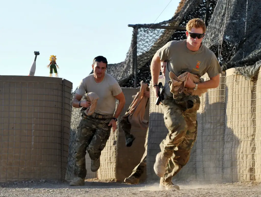 File photo: Prince Harry, right, races to his Apache helicopter at the British-controlled flight-line in Camp Bastion in southern Afghanistan on November 3, 2012.