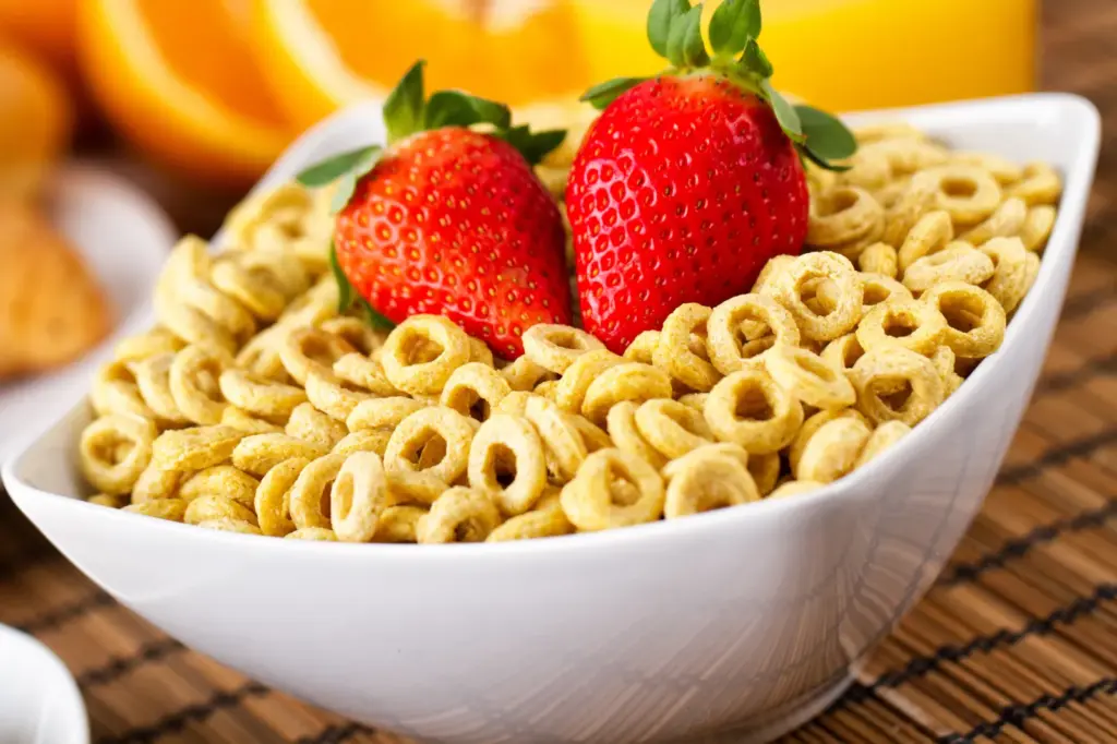 Stick image of a bowl of cereal with milk and strawberries.