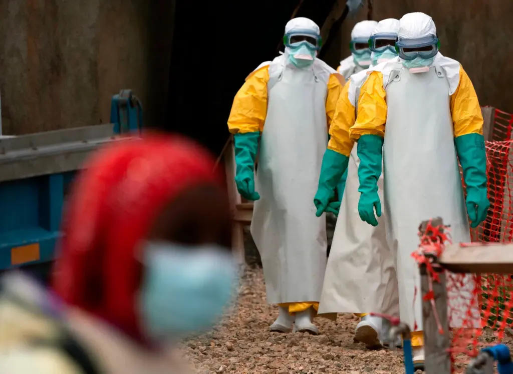 Health workers dressed in protective gear begin their shift at an Ebola treatment center in Beni, Congo, on July 16, 2019. (AP Photo/Jerome Delay, File)