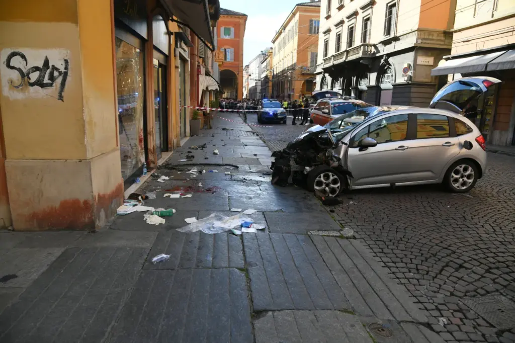 Blood is seen next to a destroyed car on a street of Modena, Italy, on May 16. (Lapresse via AP)