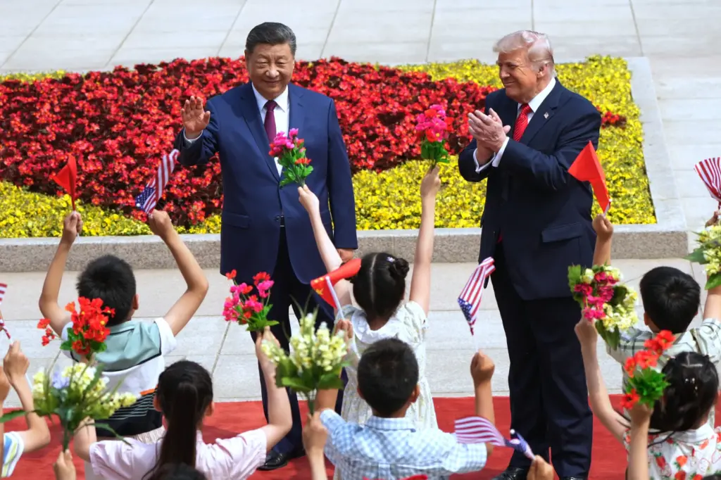 President Donald Trump and China's President Xi Jinping greet children during a welcome ceremony at the Great Hall of the People, Thursday, May 14, 2026, in Beijing. (AP Photo/Mark Schiefelbein)